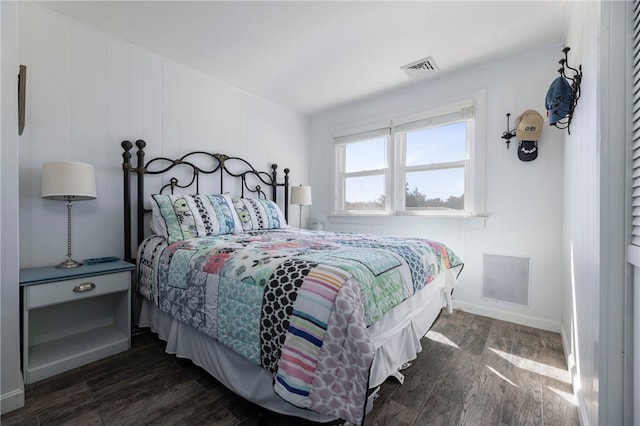 bedroom featuring visible vents, baseboards, and dark wood-style flooring