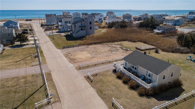 drone / aerial view with a residential view and a water view