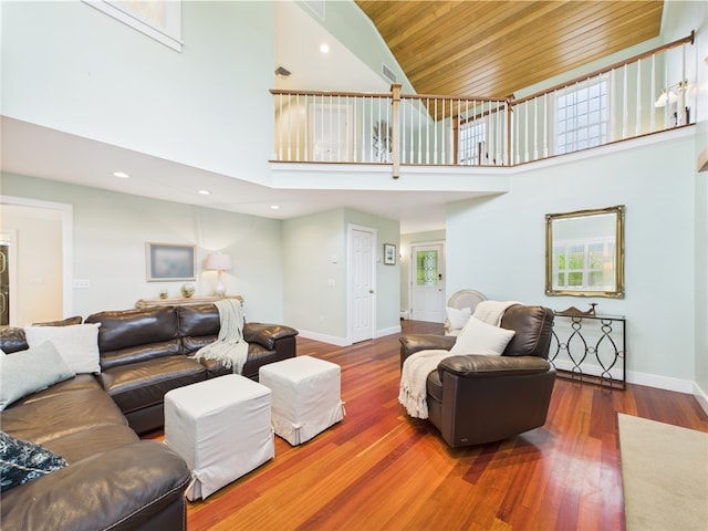 living room featuring wood ceiling, high vaulted ceiling, baseboards, wood finished floors, and recessed lighting