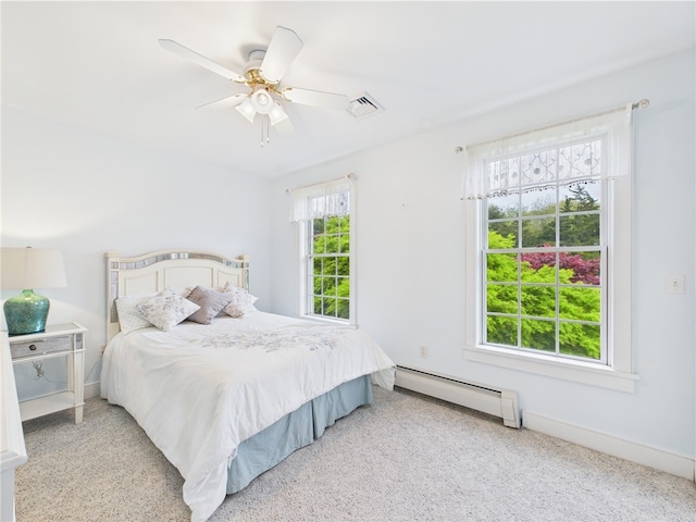 carpeted bedroom featuring a baseboard radiator, ceiling fan, and baseboards