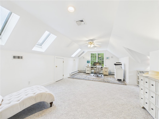 bedroom featuring a skylight, light carpet, vaulted ceiling, a baseboard radiator, and an office area