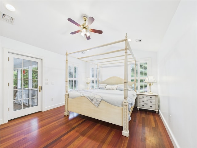 bedroom with access to exterior, multiple windows, vaulted ceiling, wood finished floors, and baseboards