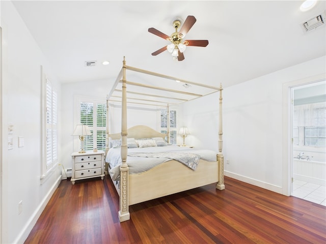 bedroom with baseboards, wood finished floors, vaulted ceiling, connected bathroom, and a ceiling fan