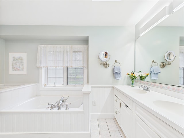 bathroom with a wainscoted wall, a garden tub, double vanity, and tile patterned floors