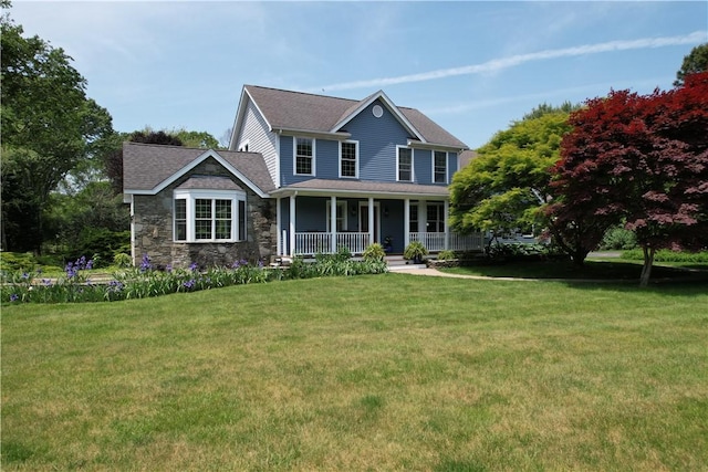 50 Intrepid Ln, Jamestown, RI 02835 - view of front of home with covered porch, a front yard, and stone siding