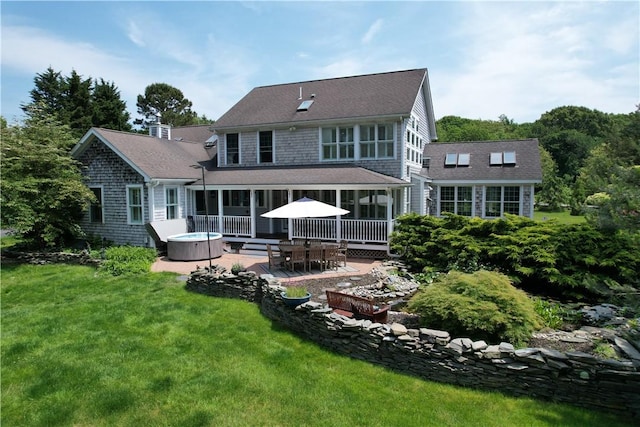 50 Intrepid Ln, Jamestown, RI 02835 - back of house featuring a hot tub, a patio area, a yard, and a shingled roof