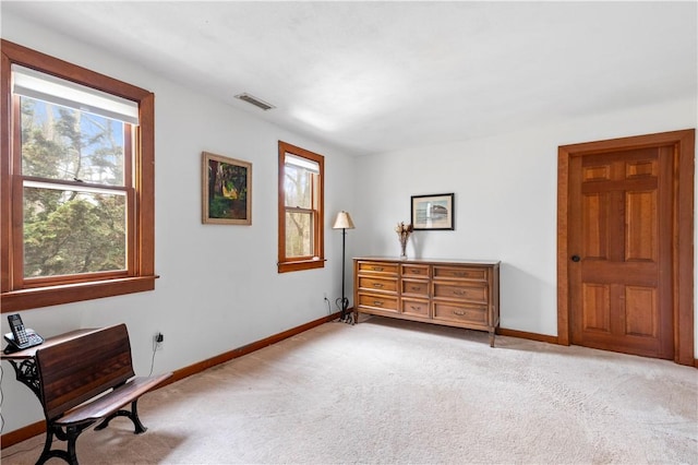 sitting room with baseboards, visible vents, carpet flooring, and a wealth of natural light