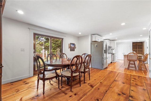 dining area featuring baseboards, light wood-style floors, and recessed lighting
