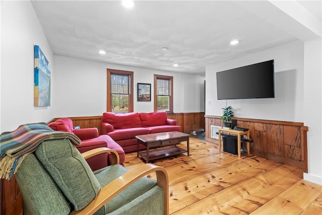 living area with wood walls, a wainscoted wall, wood finished floors, and recessed lighting
