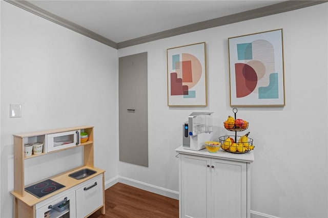 interior space with ornamental molding, baseboards, and dark wood-style flooring