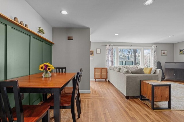 dining room featuring light wood-style flooring, baseboards, and recessed lighting