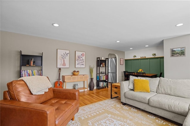living area with light wood-type flooring and recessed lighting