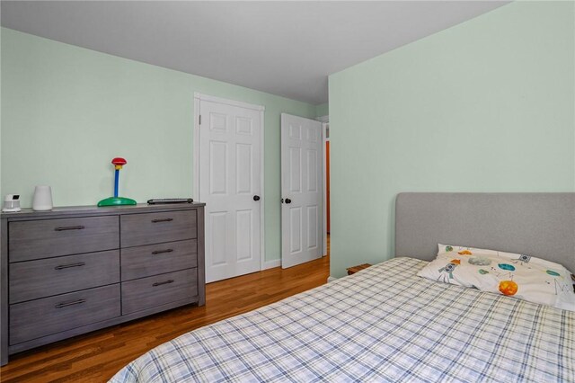 bedroom featuring dark wood-style flooring