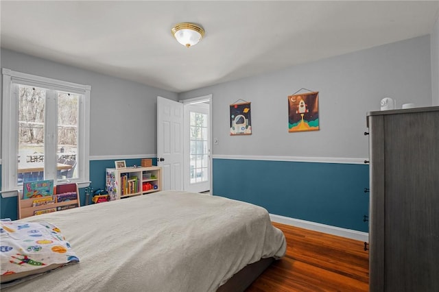 bedroom featuring baseboards and wood finished floors