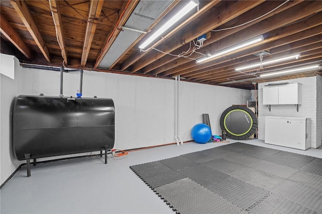 below grade area featuring refrigerator and heating fuel