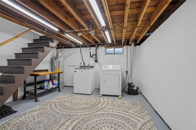 below grade area with independent washer and dryer, stairway, and electric water heater