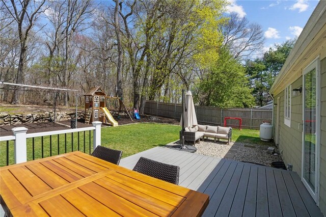 wooden deck with a playground, a fenced backyard, outdoor dining area, a yard, and an outdoor hangout area
