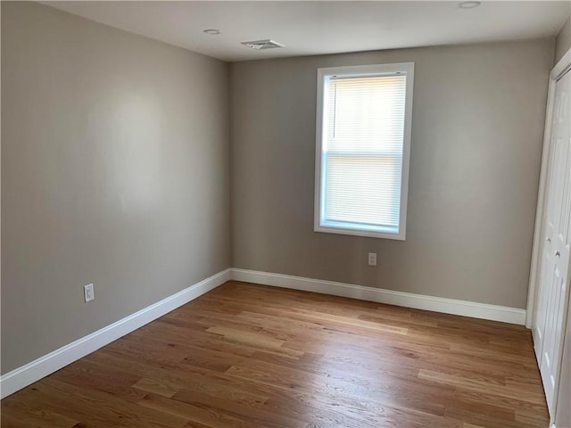 88 Reed St, Warwick, RI 02886 - unfurnished bedroom featuring wood finished floors and a closet