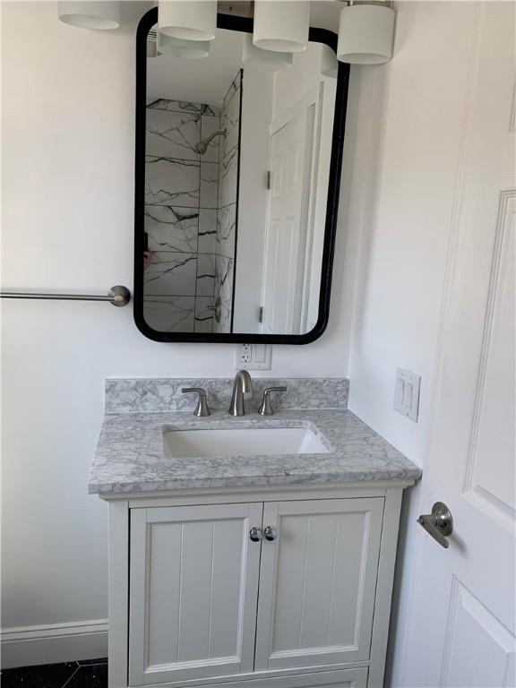 88 Reed St, Warwick, RI 02886 - full bath featuring baseboards, vanity, and a shower