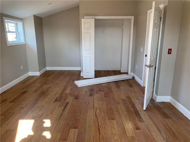88 Reed St, Warwick, RI 02886 - unfurnished bedroom featuring baseboards, wood finished floors, and a closet