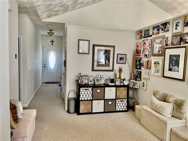 carpeted entrance foyer featuring baseboards