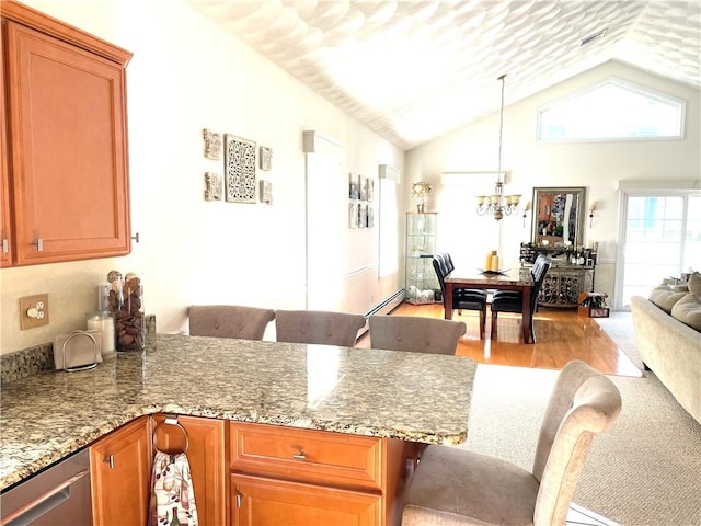 kitchen with a peninsula, stainless steel dishwasher, light wood-type flooring, open floor plan, and a chandelier