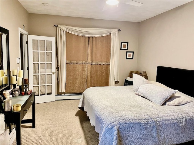bedroom with a baseboard radiator, carpet, and a ceiling fan