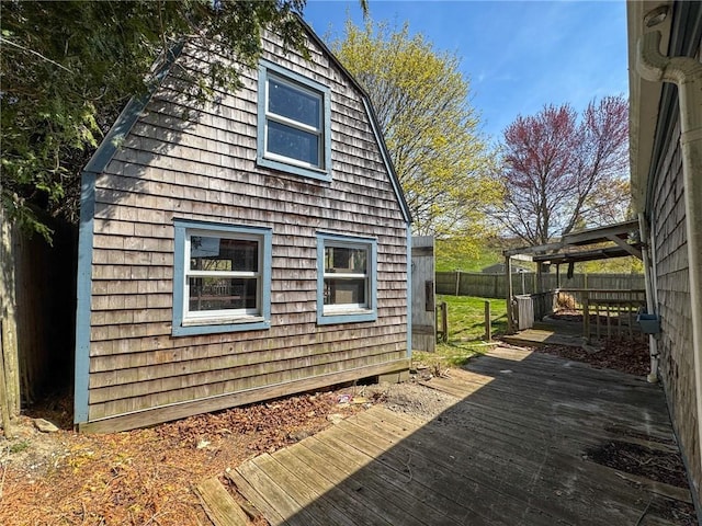 8 Tucker Ave, Tiverton, RI 02878 - view of property exterior featuring a wooden deck and fence
