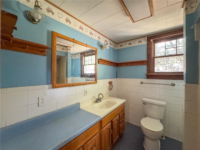 8 Tucker Ave, Tiverton, RI 02878 - bathroom with tile walls, toilet, vanity, and wainscoting