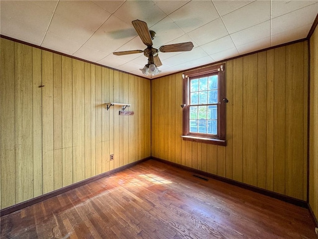8 Tucker Ave, Tiverton, RI 02878 - empty room with wooden walls, wood finished floors, and a ceiling fan