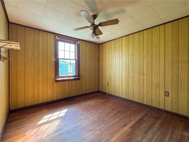 8 Tucker Ave, Tiverton, RI 02878 - empty room featuring wooden walls, visible vents, baseboards, ceiling fan, and hardwood / wood-style flooring