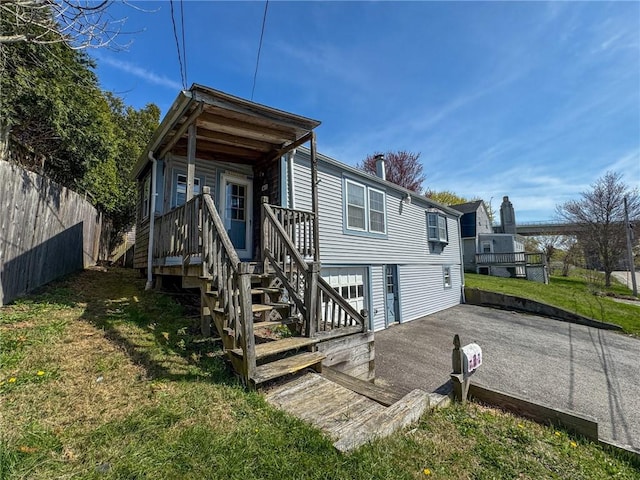 8 Tucker Ave, Tiverton, RI 02878 - back of property with a yard, fence, and a deck