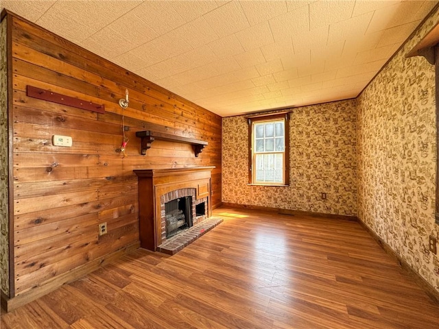 8 Tucker Ave, Tiverton, RI 02878 - unfurnished living room featuring baseboards, wood finished floors, wallpapered walls, and a fireplace