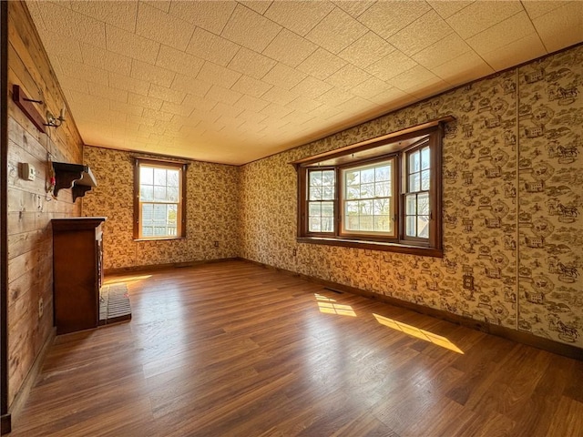 8 Tucker Ave, Tiverton, RI 02878 - unfurnished living room featuring wallpapered walls, wood finished floors, and baseboards