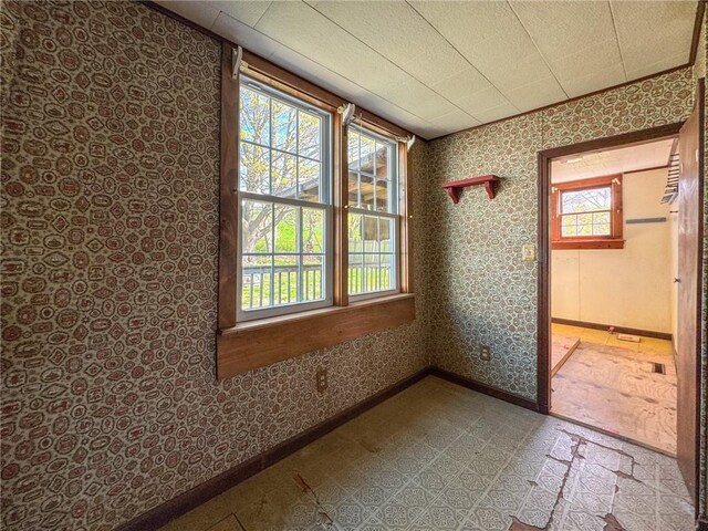 8 Tucker Ave, Tiverton, RI 02878 - spare room with wallpapered walls, tile patterned floors, and baseboards