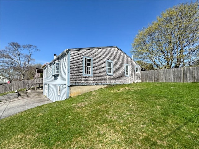 8 Tucker Ave, Tiverton, RI 02878 - view of home's exterior with a yard, concrete driveway, and fence