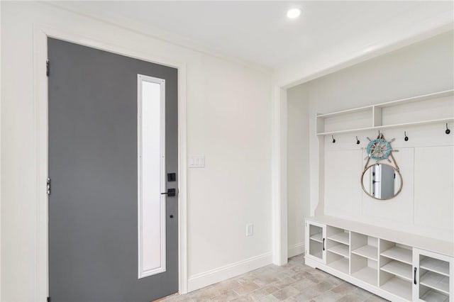 mudroom with recessed lighting and baseboards