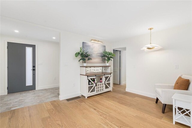 foyer entrance featuring recessed lighting, baseboards, and light wood-style flooring