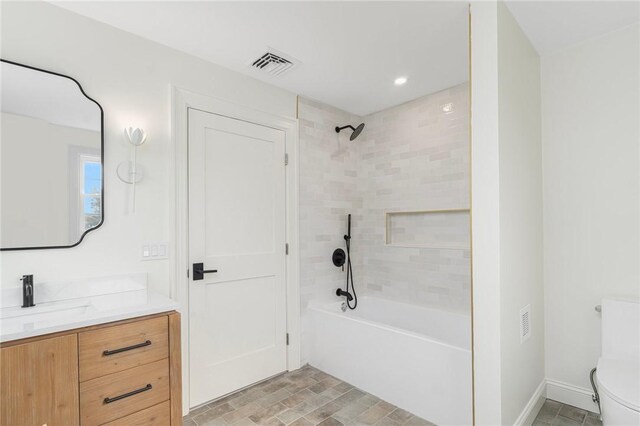 bathroom with shower / washtub combination, visible vents, toilet, vanity, and baseboards