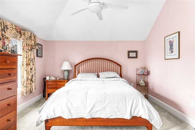 bedroom with light colored carpet, baseboards, ceiling fan, and lofted ceiling