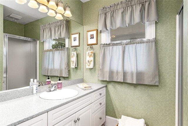 bathroom with vanity and an enclosed shower