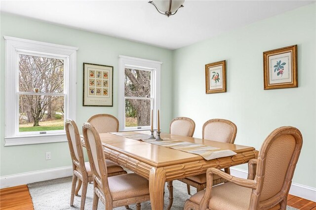 dining room featuring baseboards and light wood-type flooring