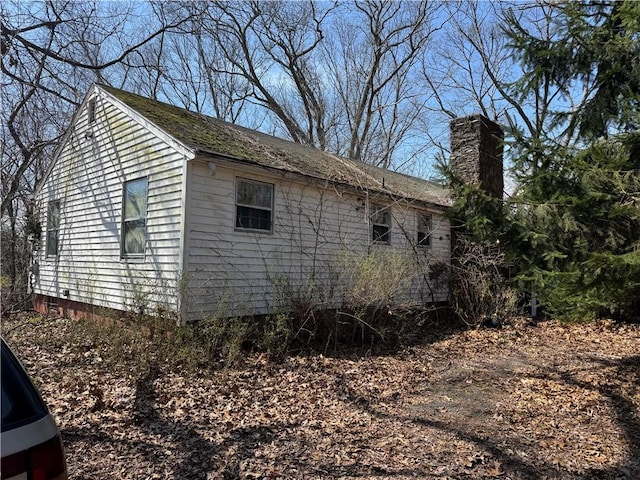 view of side of property with a chimney