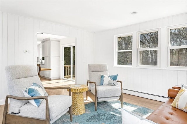 living area featuring light wood-style floors and a baseboard radiator