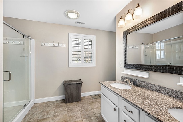 full bathroom featuring plenty of natural light, baseboards, visible vents, and a shower stall