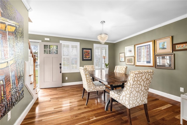 dining room featuring crown molding, baseboards, an inviting chandelier, and wood finished floors