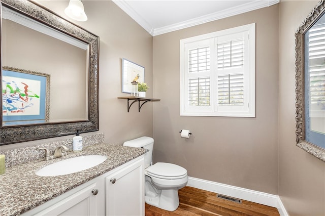 bathroom featuring visible vents, crown molding, wood finished floors, baseboards, and toilet