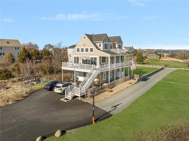 57 Foster St, Warwick, RI 02889 - view of front facade with a front lawn, stairway, a deck, and a balcony