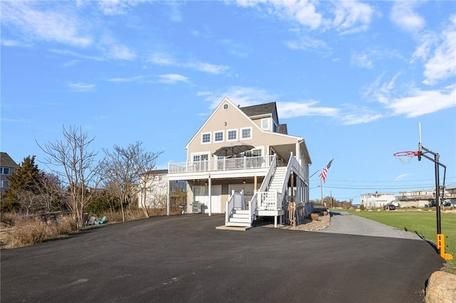 57 Foster St, Warwick, RI 02889 - view of front of property featuring covered porch, aphalt driveway, stairs, and an attached garage