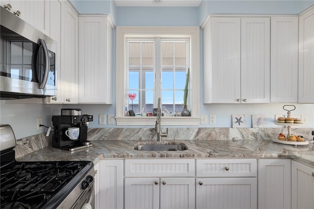 57 Foster St, Warwick, RI 02889 - kitchen featuring white cabinetry, stainless steel appliances, and a sink